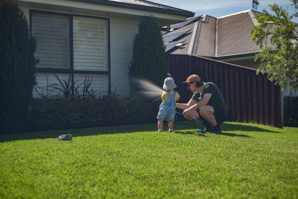 A man and child watering their garden